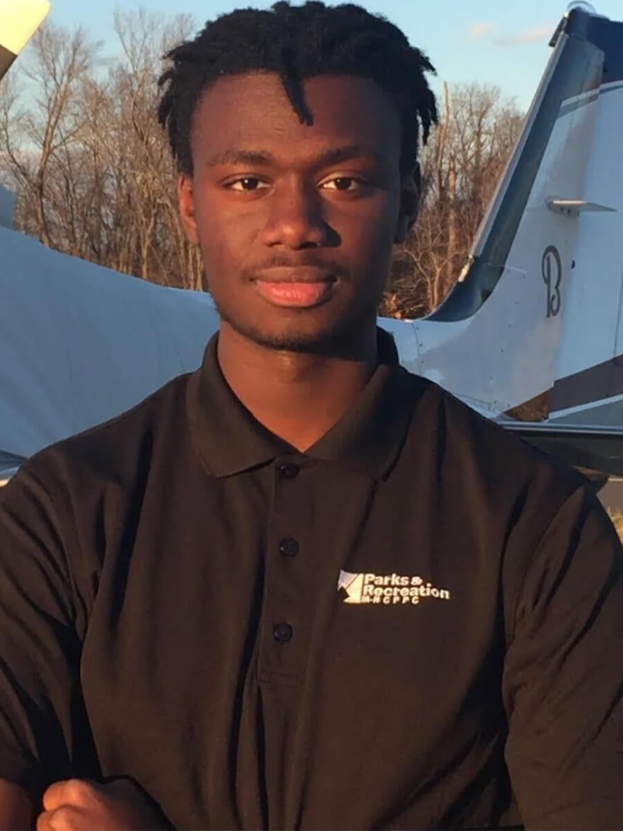 Amadou's headshot features a man slightly smiling and wearing a black polo.