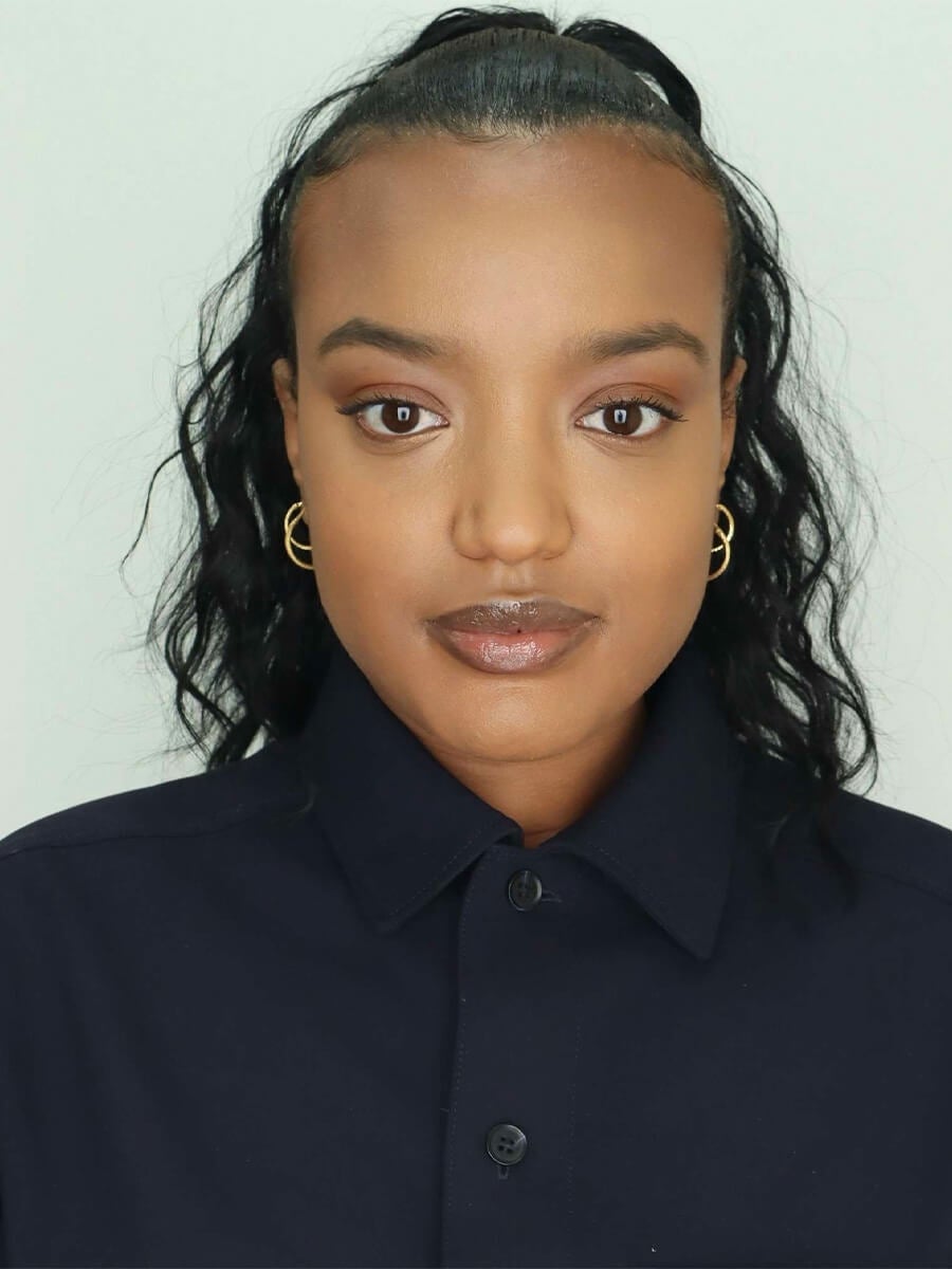 Soliana's headshot features a woman looking directly center wearing a black top. 