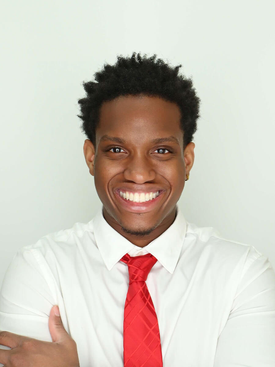 headshot of student wearing white collard shirt and red tie