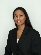 Headshot of a woman wearing a black blazer with a slight smile